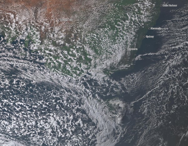Visible satellite image of 'speckled' cloud spreading across TAS, VIC and SA, demonstrating the cold airmass