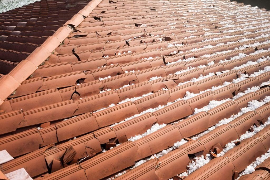 65945bb3044aa7d99f85bc3a_hail-damage-on-concrete-tile-1024x683